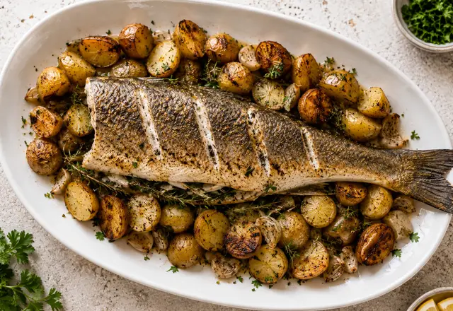 Oven roasted whole branzino with lemon slices and herbs