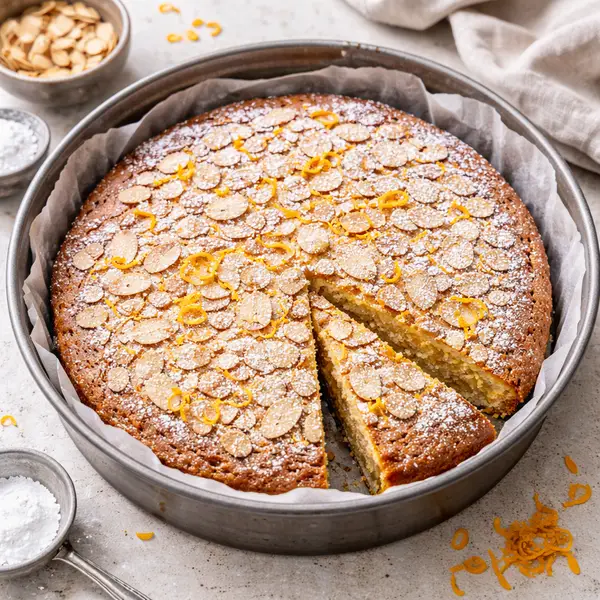 golden almond cake dusted with powdered sugar